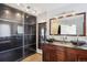 Modern main bathroom featuring dual vanities, dark cabinetry, and a large sliding door closet at 618 S Carlton St, Castle Rock, CO 80104