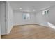 Spacious basement room features wood-look flooring and egress windows at 5224 Scranton Ct, Denver, CO 80239