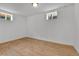 Finished basement space with wood-look floors and multiple windows at 5224 Scranton Ct, Denver, CO 80239