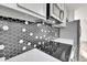 Updated kitchen features stylish hexagon backsplash, quartz countertops, and stainless steel appliances at 5224 Scranton Ct, Denver, CO 80239