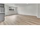 Open concept living room featuring new flooring and abundant natural light at 5224 Scranton Ct, Denver, CO 80239