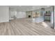 Spacious living room features a stone fireplace, updated flooring, and a kitchen island at 5224 Scranton Ct, Denver, CO 80239
