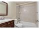 Bathroom featuring a wood vanity and shower-tub combo at 12790 Jackson St, Thornton, CO 80241