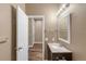 Well-lit bathroom boasts modern fixtures, neutral color scheme, and wood-look floors at 12790 Jackson St, Thornton, CO 80241