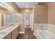 Primary bathroom with double vanity, soaking tub, and glass-enclosed shower at 12790 Jackson St, Thornton, CO 80241