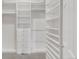 Walk-in closet with custom shelving and drawers maximizes storage and organization at 12790 Jackson St, Thornton, CO 80241
