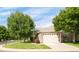 Exterior view of a stone home with an attached garage at 12790 Jackson St, Thornton, CO 80241