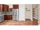 Kitchen with stainless steel refrigerator and wood cabinets at 12790 Jackson St, Thornton, CO 80241