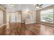 Bright living room features hardwood floors, large windows, and a ceiling fan at 12790 Jackson St, Thornton, CO 80241