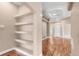 Open living area with built-in shelves and wood floors at 12790 Jackson St, Thornton, CO 80241