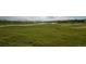 Vast open field with a walking path and pond in the distance, perfect for recreation at 12790 Jackson St, Thornton, CO 80241