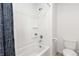 Bathroom featuring a shower over tub and white tiling at 3074 Belleville Ridge Rd, Elizabeth, CO 80107