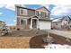 Charming two-story home featuring stone accents, a two-car garage and professionally landscaped yard with rock and mulch at 3074 Belleville Ridge Rd, Elizabeth, CO 80107