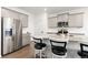 Modern kitchen featuring stainless steel appliances, gray cabinets, and a large island with bar seating at 3074 Belleville Ridge Rd, Elizabeth, CO 80107