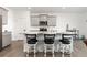 Bright kitchen with breakfast bar seating, stainless steel appliances, granite countertops and modern white cabinets at 3074 Belleville Ridge Rd, Elizabeth, CO 80107