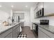 Well-lit kitchen with stainless steel appliances, gray cabinets, and granite countertops at 3074 Belleville Ridge Rd, Elizabeth, CO 80107