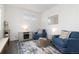 Cozy living room with blue armchairs, an area rug, and a faux fireplace at 3074 Belleville Ridge Rd, Elizabeth, CO 80107
