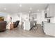 Bright, open-concept kitchen and living area with hardwood floors and a center island at 3074 Belleville Ridge Rd, Elizabeth, CO 80107