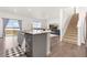 Bright and open living area with island, modern appliances, and an adjacent living space at 3074 Belleville Ridge Rd, Elizabeth, CO 80107