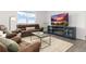 Bright living room with a modern TV stand, comfortable seating, and large windows at 3074 Belleville Ridge Rd, Elizabeth, CO 80107