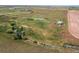 Aerial shot of the expansive lot featuring a house, barn, and pond, showcasing rural living at its finest at 39633 E 160Th Ave, Keenesburg, CO 80643