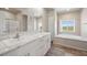 Spa-like bathroom with double sinks, a soaking tub, and contemporary fixtures, offering a luxurious retreat at 39633 E 160Th Ave, Keenesburg, CO 80643
