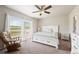 Bright bedroom with a comfortable bed, soft carpet, and a ceiling fan at 39633 E 160Th Ave, Keenesburg, CO 80643