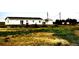 Charming ranch-style home with green, overgrown lawn and detached outbuilding at 39633 E 160Th Ave, Keenesburg, CO 80643