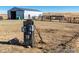 Exterior shot features gray electrical box, barn with roll-up door, and some old farm equipment at 39633 E 160Th Ave, Keenesburg, CO 80643