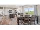 Spacious kitchen area featuring a dining table, center island, and sliding doors overlooking a field at 39633 E 160Th Ave, Keenesburg, CO 80643