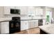 Modern kitchen with stainless steel appliances, white cabinets, and dark countertops at 39633 E 160Th Ave, Keenesburg, CO 80643