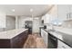 Modern kitchen with white cabinets, island, stainless appliances, and plenty of counter space at 39633 E 160Th Ave, Keenesburg, CO 80643