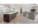 Bright and inviting living area featuring wood flooring, a kitchen island, and comfortable seating at 39633 E 160Th Ave, Keenesburg, CO 80643