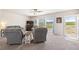 Inviting living room with plush seating, neutral tones, and plenty of natural light at 39633 E 160Th Ave, Keenesburg, CO 80643