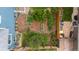 Aerial view of backyard featuring a garden, shed, wood fencing, mature trees, and green lawn at 21885 Whirlaway Ave, Parker, CO 80138