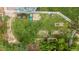 Aerial view of the backyard with a garden, lush lawn, sandbox, and mature trees at 21885 Whirlaway Ave, Parker, CO 80138