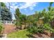 Picturesque backyard with a combination of lush lawn, mature trees, and mulched garden areas at 21885 Whirlaway Ave, Parker, CO 80138