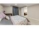 Cozy bedroom featuring a floral bedspread, a small desk, and an open doorway to the living area at 21885 Whirlaway Ave, Parker, CO 80138