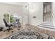 Welcoming foyer with high ceilings, large window, staircase, wood-look flooring, and neutral decor at 21885 Whirlaway Ave, Parker, CO 80138