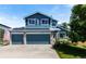 Charming two-story home with a three-car garage, blue siding, manicured lawn, solar panels, and American flag at 21885 Whirlaway Ave, Parker, CO 80138