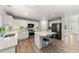Bright and spacious kitchen with white cabinets, stainless steel appliances, large island with seating at 21885 Whirlaway Ave, Parker, CO 80138