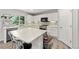Bright kitchen with white cabinets, stainless steel appliances, large center island, and modern backsplash at 21885 Whirlaway Ave, Parker, CO 80138