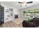 Bright living room features built-in shelving, a cozy fireplace, and large windows for natural light at 21885 Whirlaway Ave, Parker, CO 80138