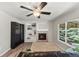 Bright living room features built-in shelving, a cozy fireplace, and large windows for natural light at 21885 Whirlaway Ave, Parker, CO 80138