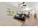 Bright living room with large window, hardwood floors, view to kitchen, and comfortable seating at 21885 Whirlaway Ave, Parker, CO 80138