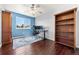 Bright office with large window, dark wood floors and built-in bookcase at 21885 Whirlaway Ave, Parker, CO 80138