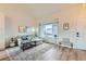 Inviting living room with large window, modern decor, and laminate wood flooring at 13547 Quivas St, Denver, CO 80234