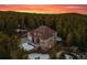 Aerial shot of a large home on wooded lot showcasing its architectural style and surroundings at 9303 Dauntless Way, Conifer, CO 80433