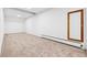 Unfurnished carpeted basement with white walls and a baseboard heater at 9303 Dauntless Way, Conifer, CO 80433