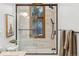 Modern bathroom featuring a shower-over-tub, a window with wooded views, and tile surround at 9303 Dauntless Way, Conifer, CO 80433